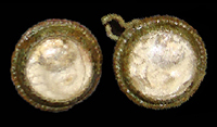 Copper alloy button settings with colorless molded glass insets. The design molded on the back of the inset appears to be a single flower bloom with its stem and two leaves. 